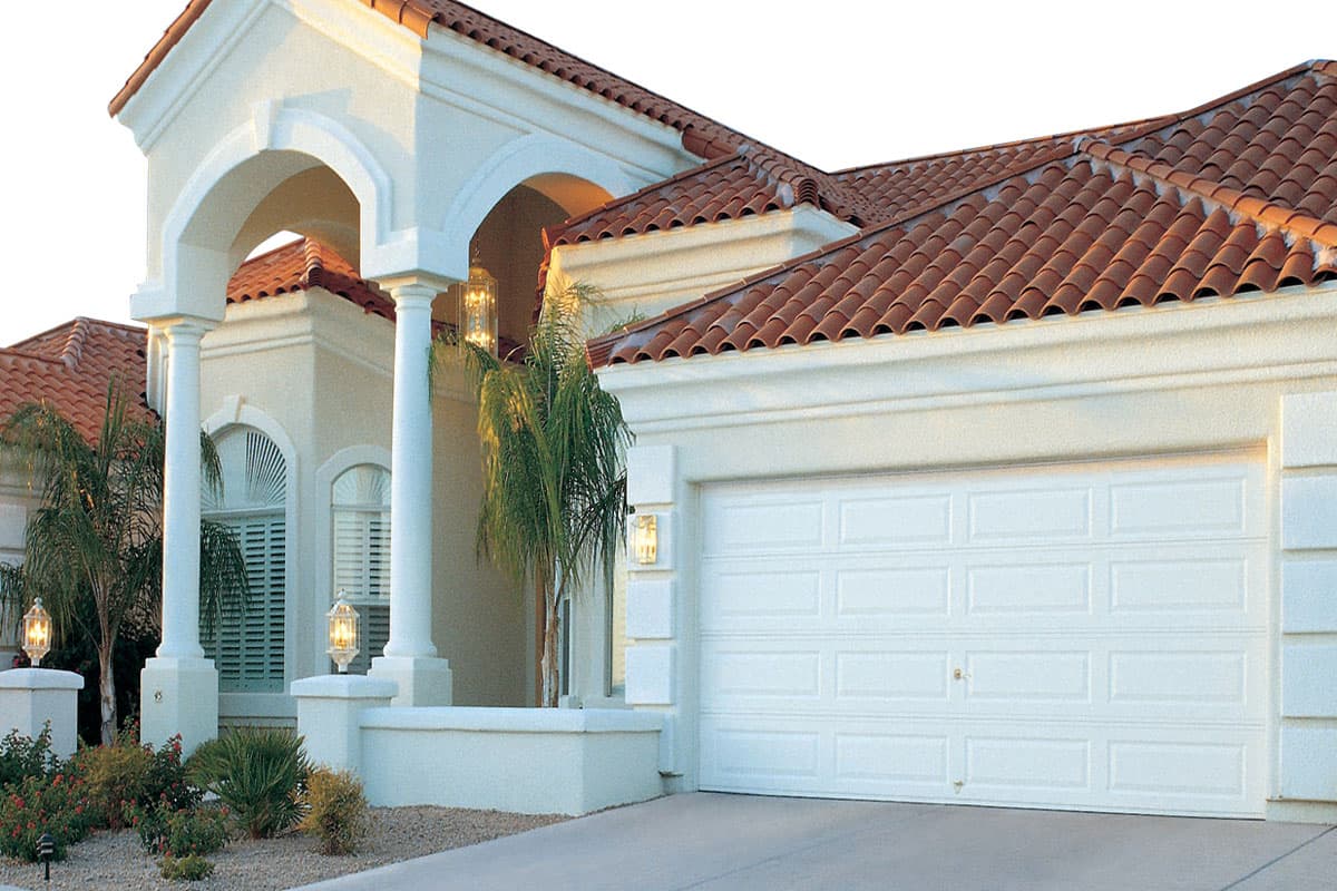 Large White House with an aluminum garage door